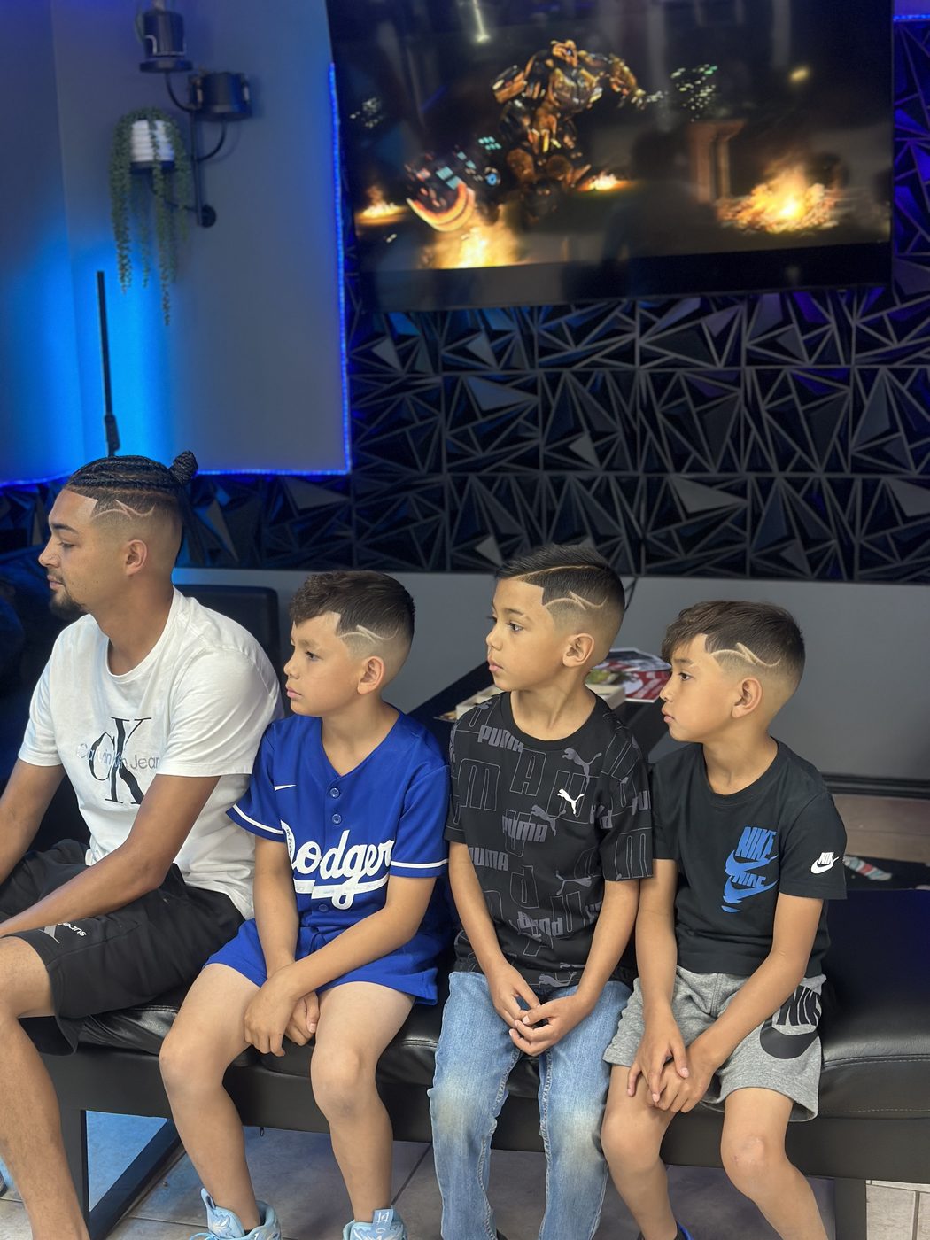 Dad and three boys with matching hair designs