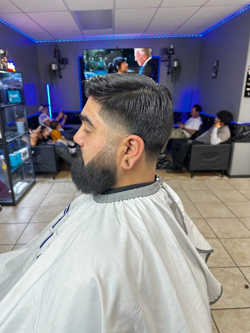 Slick side part with full beard